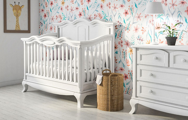 Cleopatra white carved solid wood crib and matching dresser in a floral nursery
